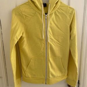 Woman’s pale yellow zip up hoodie